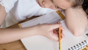 机に向かって学習する学生