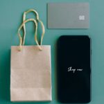 ショップの画面を表示したスマートフォンとカード