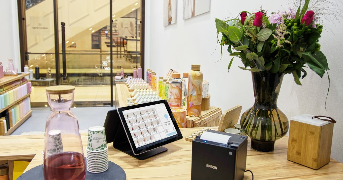 店舗レジ横のタブレット決済端末が写る店内実写。BizAirのイメージ